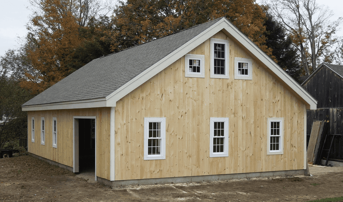 Barn board garage in natural pine with a loft and small gable windows
