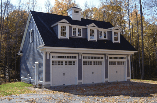 Three car detached garage with three dormers, a cupola and carriage style doors
