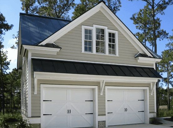 Two car garage with a bonus room above, carriage doors and a metal roof over the bays