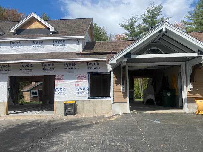 Garage addition under construction, wrapped in housewrap and tied into the existing roofline